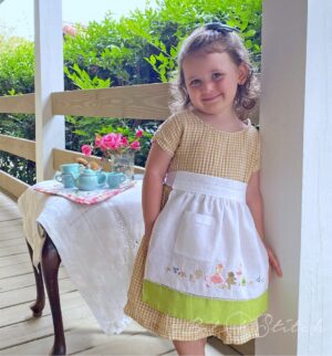 Little girl's apron made from tea towel - pattern and teatime machine embroidery border design by A Bit of Stitch