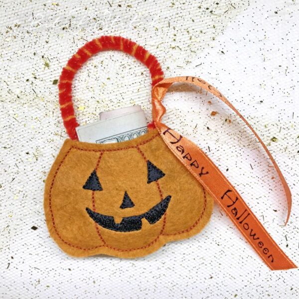 Tiny jack o lantern treat pumpkin made in the hoop with machine embroidery design by A Bit of Stitch