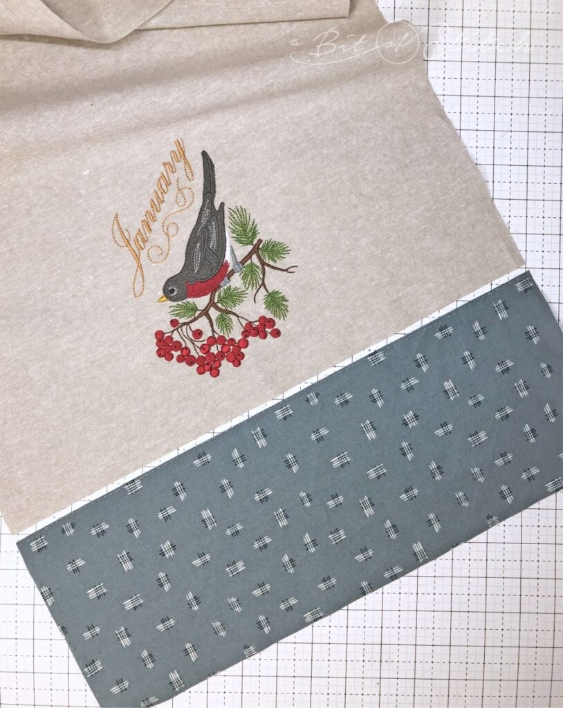 Banded tea towel with robin embroidery