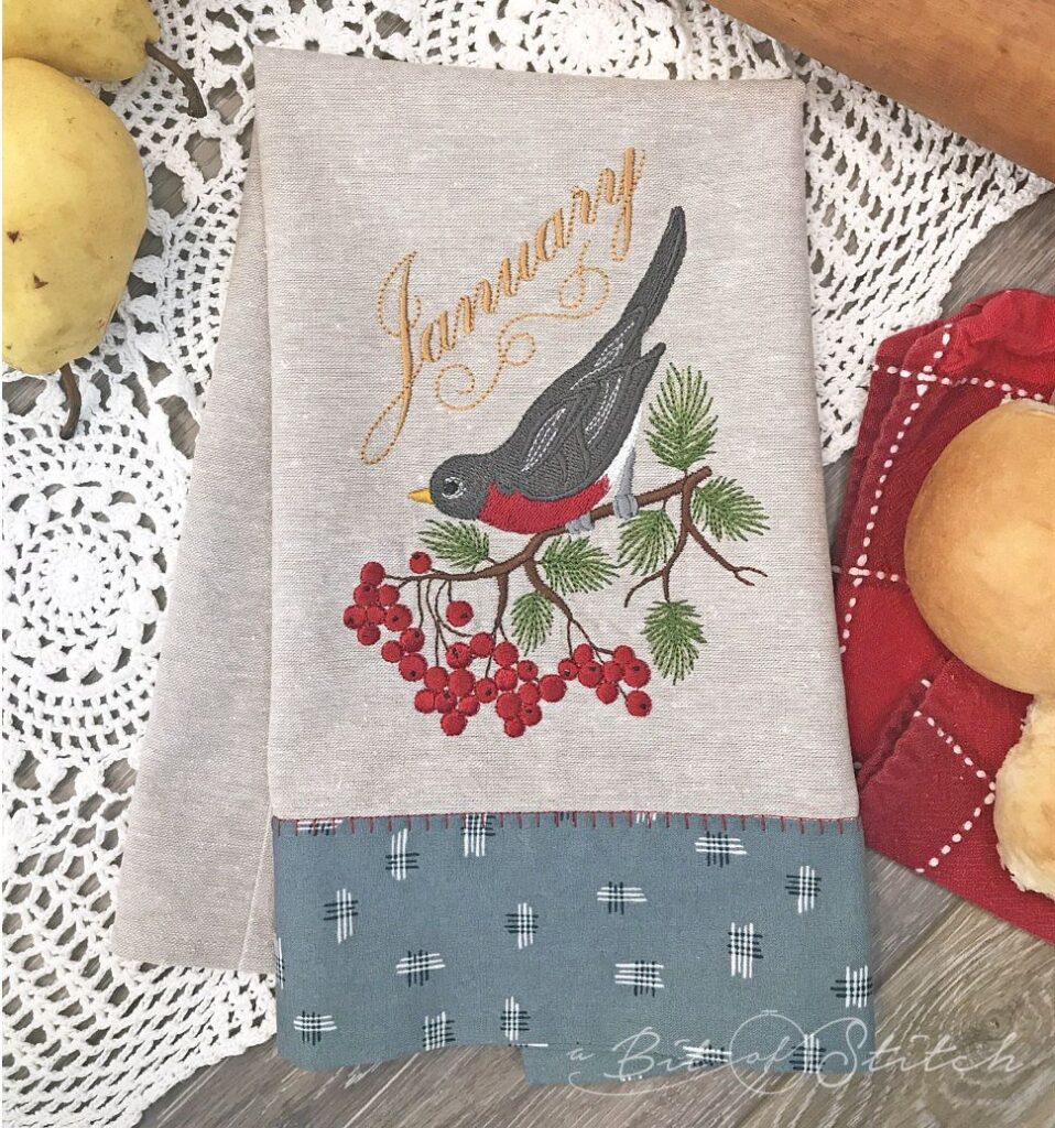 Banded tea towel with robin embroidery