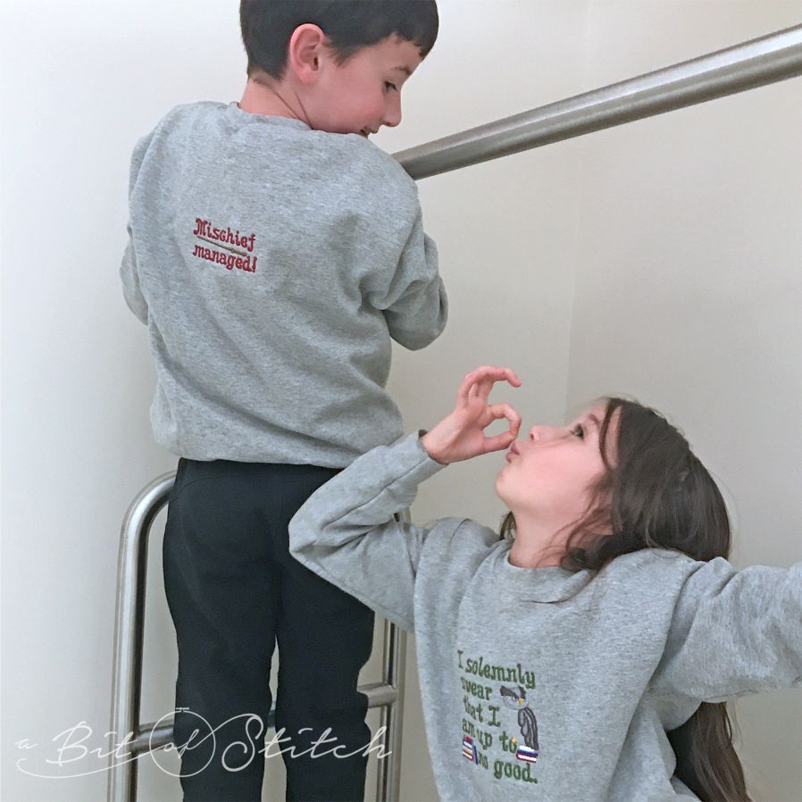 "I solemnly swear that I am up to no good" and "mischief managed" machine embroidery designs by A Bit of Stitch on children's sweatshirts