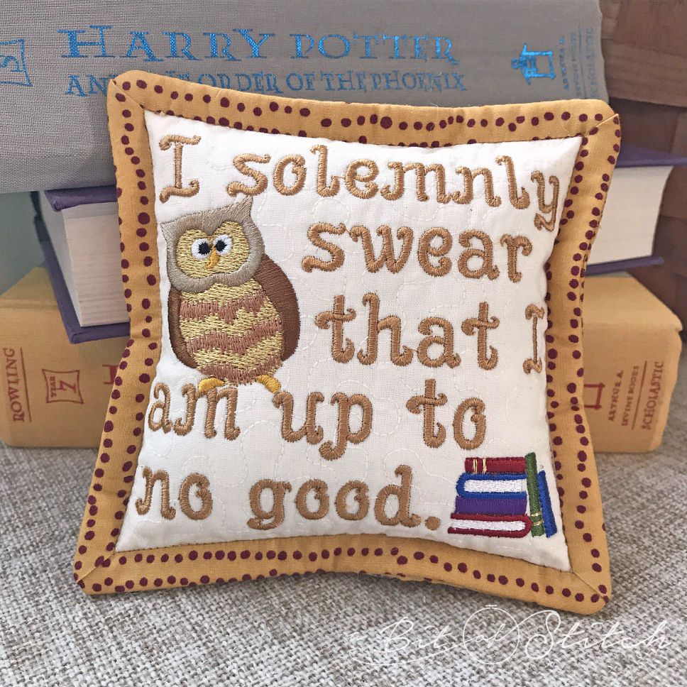 "I solemnly swear that I am up to no good" machine embroidery design by A Bit of Stitch on decorative pillow