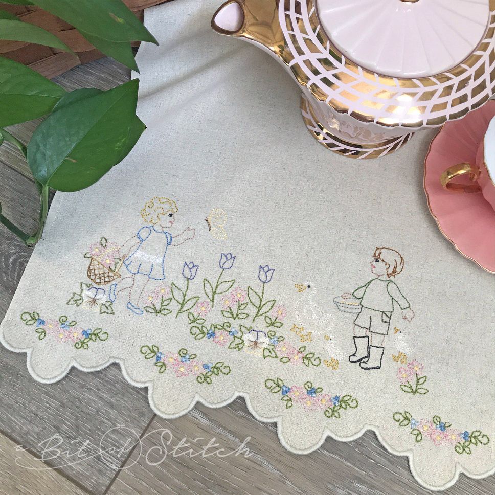 Fancy scalloped cutwork border hem on tea towel with floral spring embroidery. Machine embroidery designs by A Bit of Stitch
