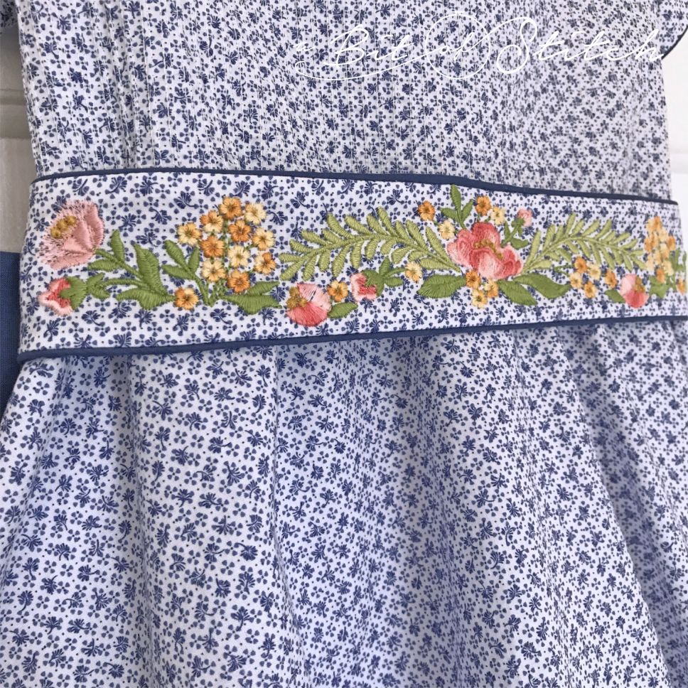 Close up of floral embroidered sash using Fiori Eleganti machine embroidery designs by A Bit of Stitch