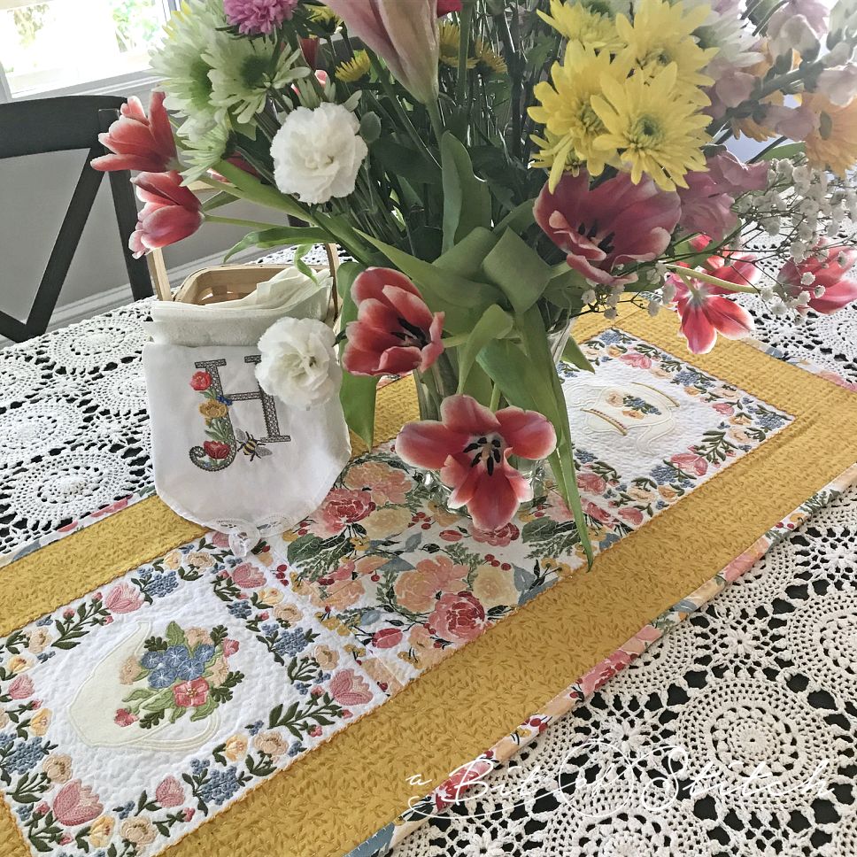 floral tea pot and flowers table runner with machine embroidery designs by A Bit of Stitch