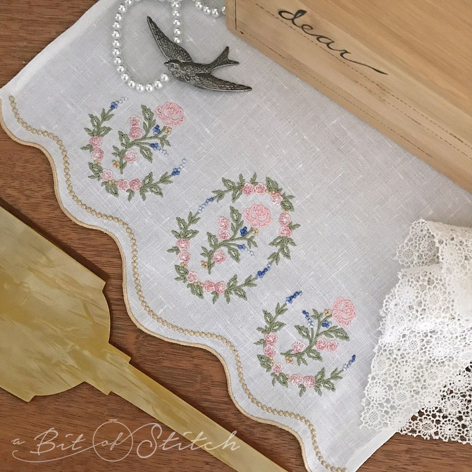 Cutwork scalloped border hem on tea towel with floral rose vine embroidery designs. Machine embroidery designs by A Bit of Stitch