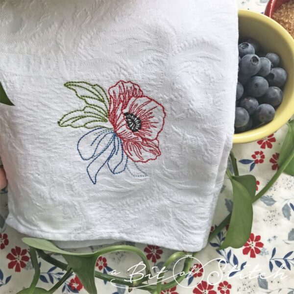 Poppy machine embroidery design by A Bit of Stitch - Memorial Day Poppy on tea towel