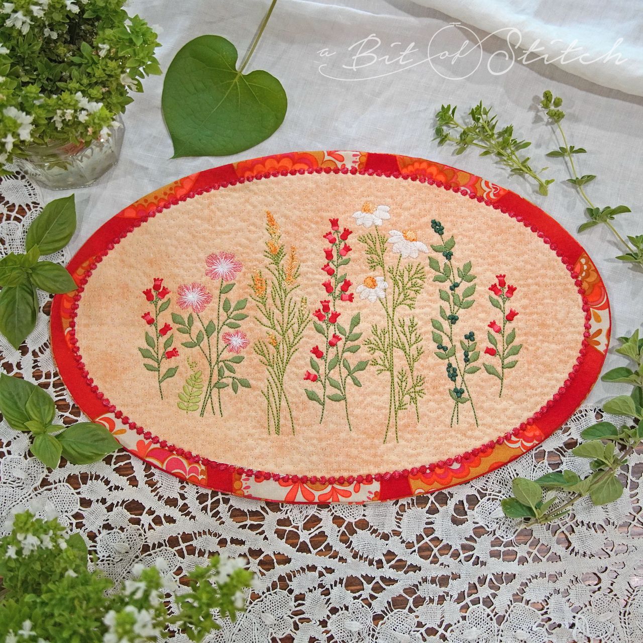 Meadow Flowers wildflower floral machine embroidery designs by A Bit of Stitch on oval shaped made-in-the-hoop doily table topper
