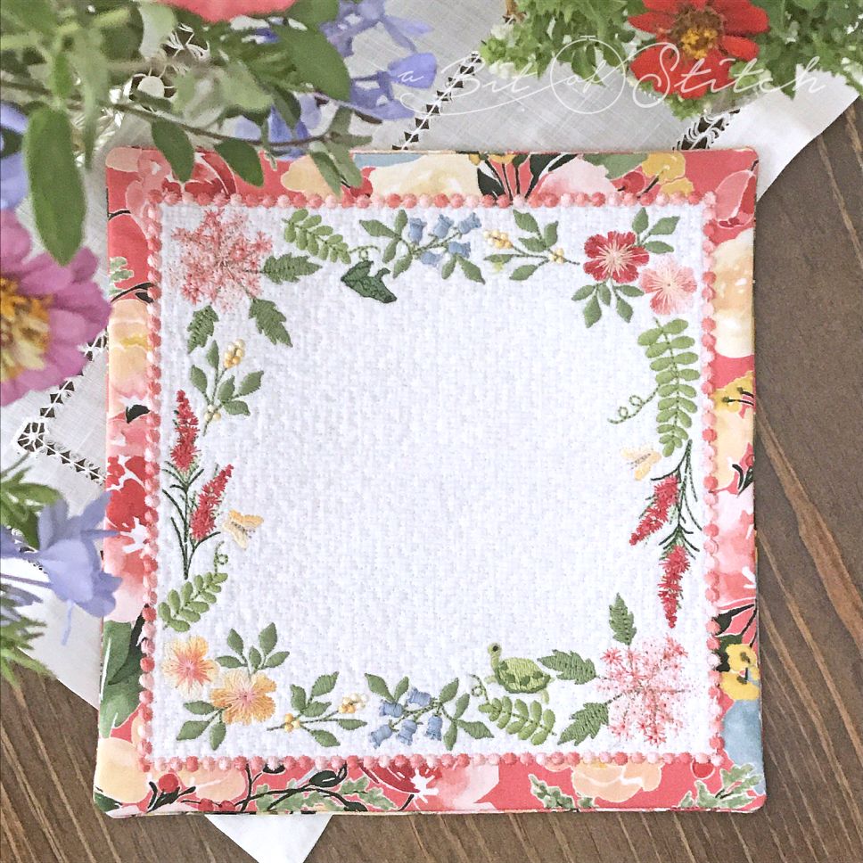 Square fabric doily made in the hoop with wildflower meadow flowers floral frame embroidery - machine embroidery designs by A Bit of Stitch