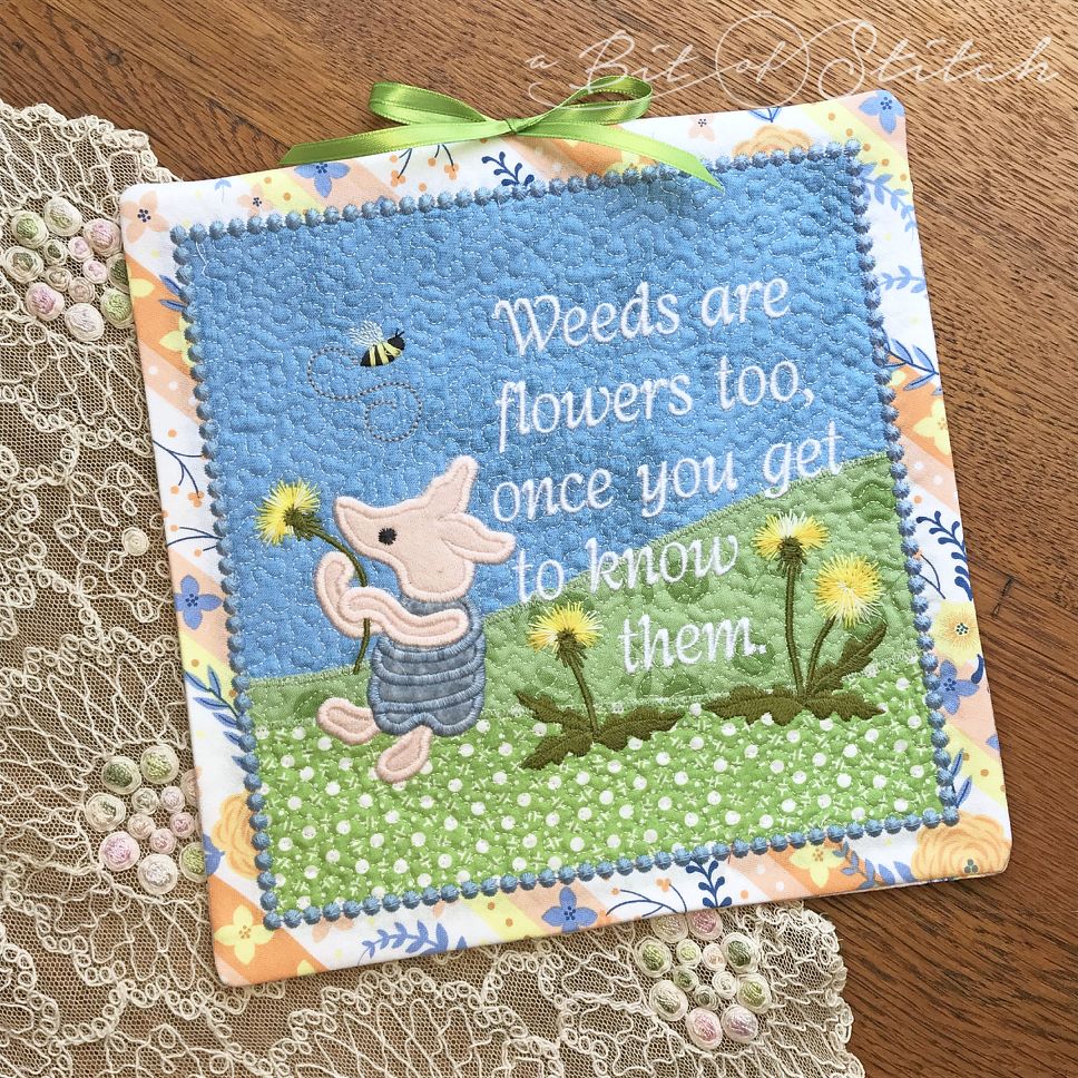 Winnie the Pooh Piglet and dandelions machine embroidery designs by A Bit of Stitch with lettering "Weeds are flowers too, once you get to know them."