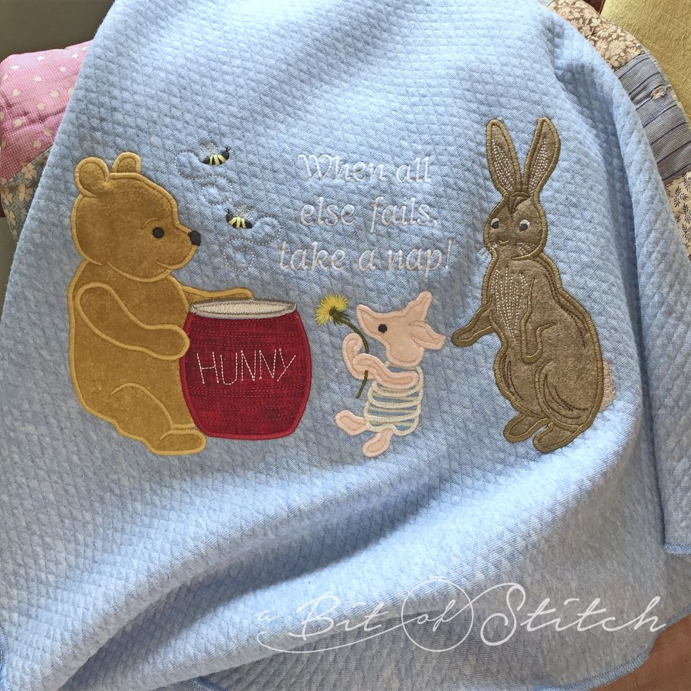 Baby blanket with Winnie the Pooh, Piglet and Rabbit machine embroidery applique designs by A Bit of Stitch with lettering "When all else fails, take a nap!"