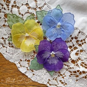 Beautiful yellow, blue and purple silk organza pansy flower brooches made with Spring Blooms machine embroidery designs from A Bit of Stitch
