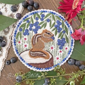 Cheeky Chipmunk with blueberries and field of flowers - machine embroidery design from A Bit of Stitch