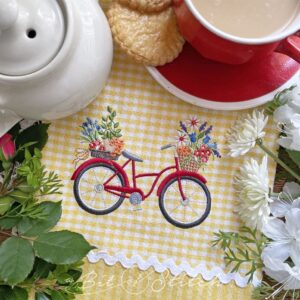 Bicycle with basket of flowers in front and flowerpots on back - machine embroidery design from A Bit of Stitch